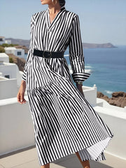 Notched long-sleeve midi dress in black and white stripe with a tiered skirt and belted waist.