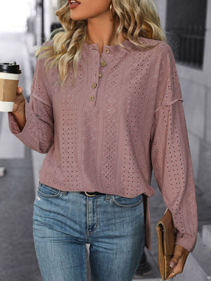Dusty pink perforated henley shirt with button detail and slit hem.
