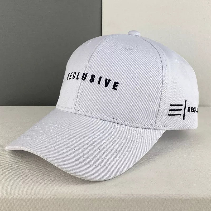White cotton baseball cap with black embroidered text and logo detail.