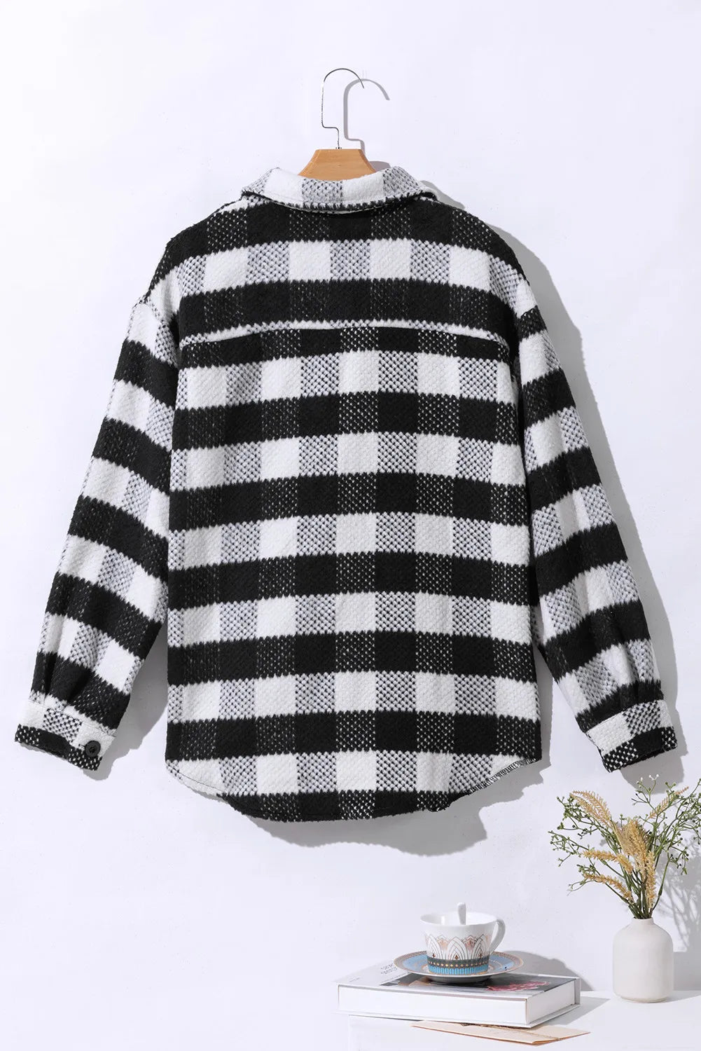 Textured checkerboard overshirt in plaid with button front and collared neckline.