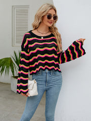 Black scalloped crochet crop sweater with pink and yellow wavy stripes, bell sleeves.