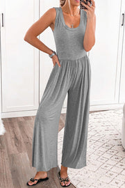 Gray gathered waist wide leg jumpsuit with scoop neck and sleeveless cut.