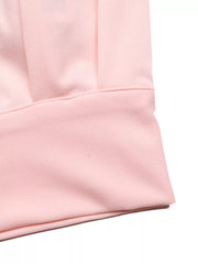 Pink pleated midi skirt set detail showing fabric texture and pleats.