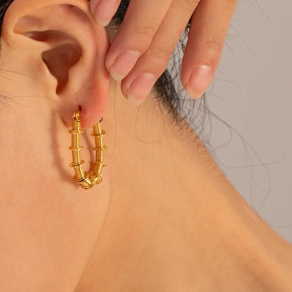 Gold coiled wire hoop earrings with stacked detail