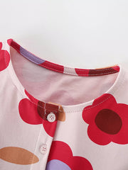 Toddler cotton dress with playful floral print, button-down front, and round neckline.