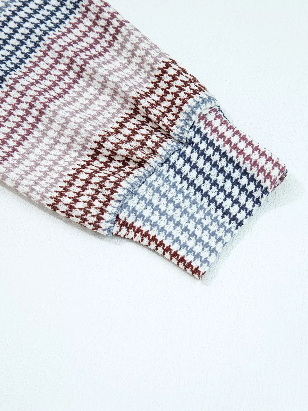 Relaxed fit hoodie sleeve with a multi-tonal houndstooth pattern in navy, burgundy, and grey.