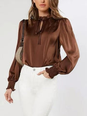 Brown satin tie-neck blouse with shirred cuffs and ruffled collar