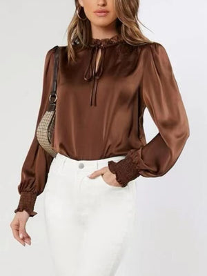 Brown satin tie-neck blouse with shirred cuffs and ruffled collar