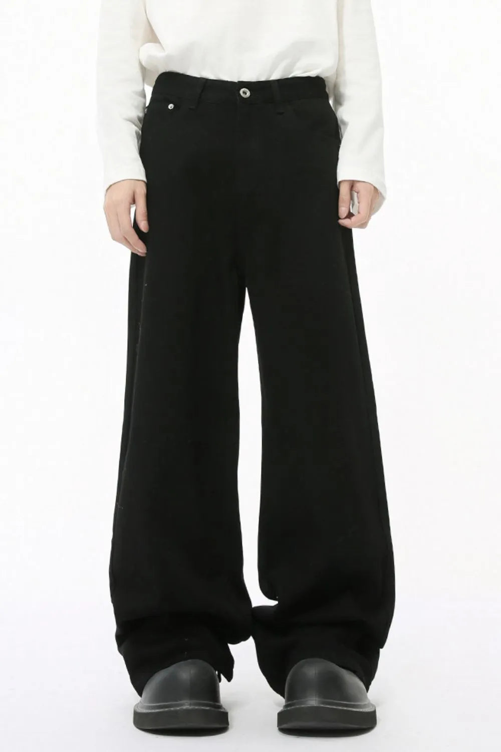Black balloon leg jeans with a faded wash and wide silhouette.