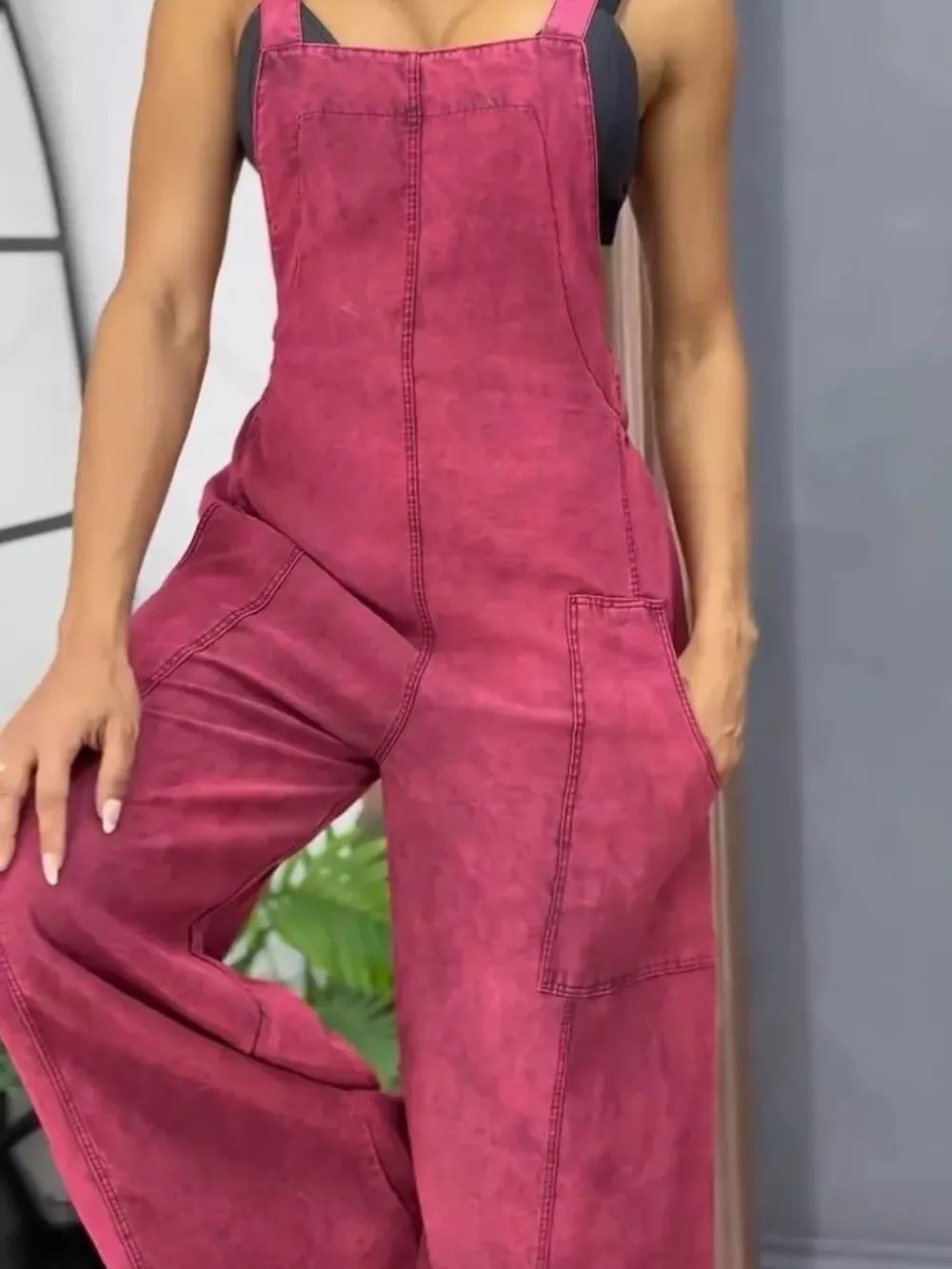 Rose red vintage wash wide-leg denim overalls with bib front and large pockets.