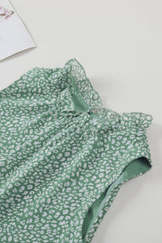 Sage green sleeveless blouse with white leopard print and ruffled neckline.
