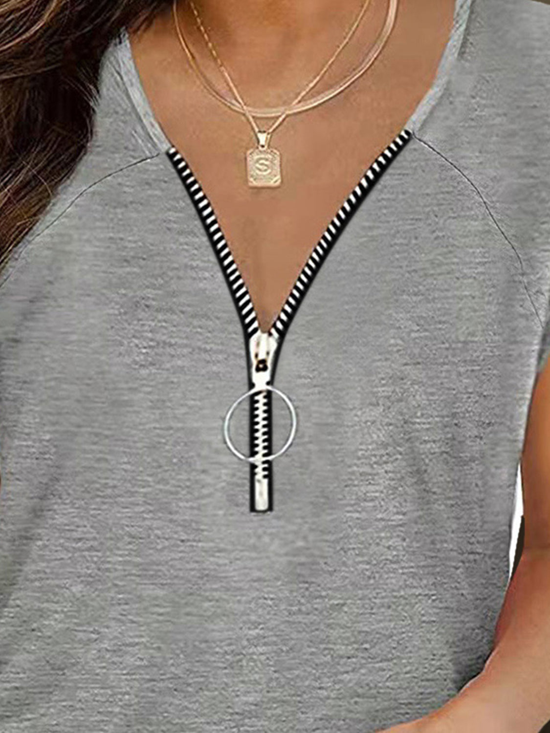 Dark gray cap-sleeve tee with zip-front detail and ring pull