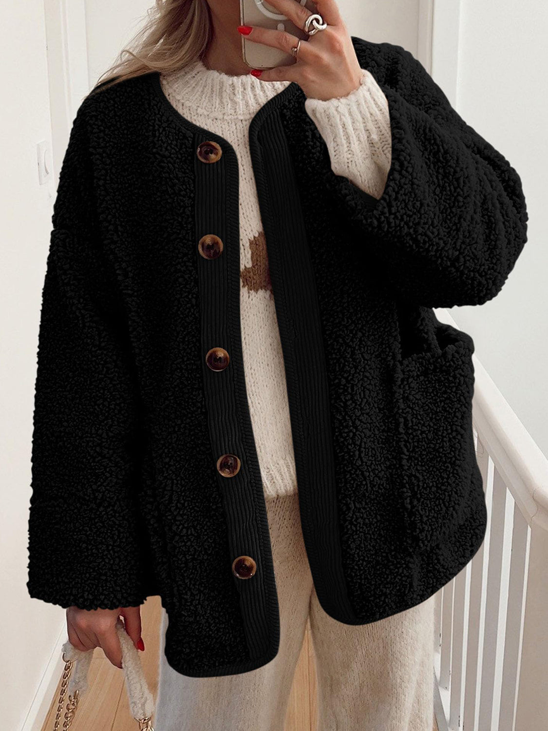 Black teddy-texture button-up jacket with corduroy trim and brown buttons.