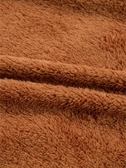 Cozy brown plush fabric texture detail of a zippered vest coat