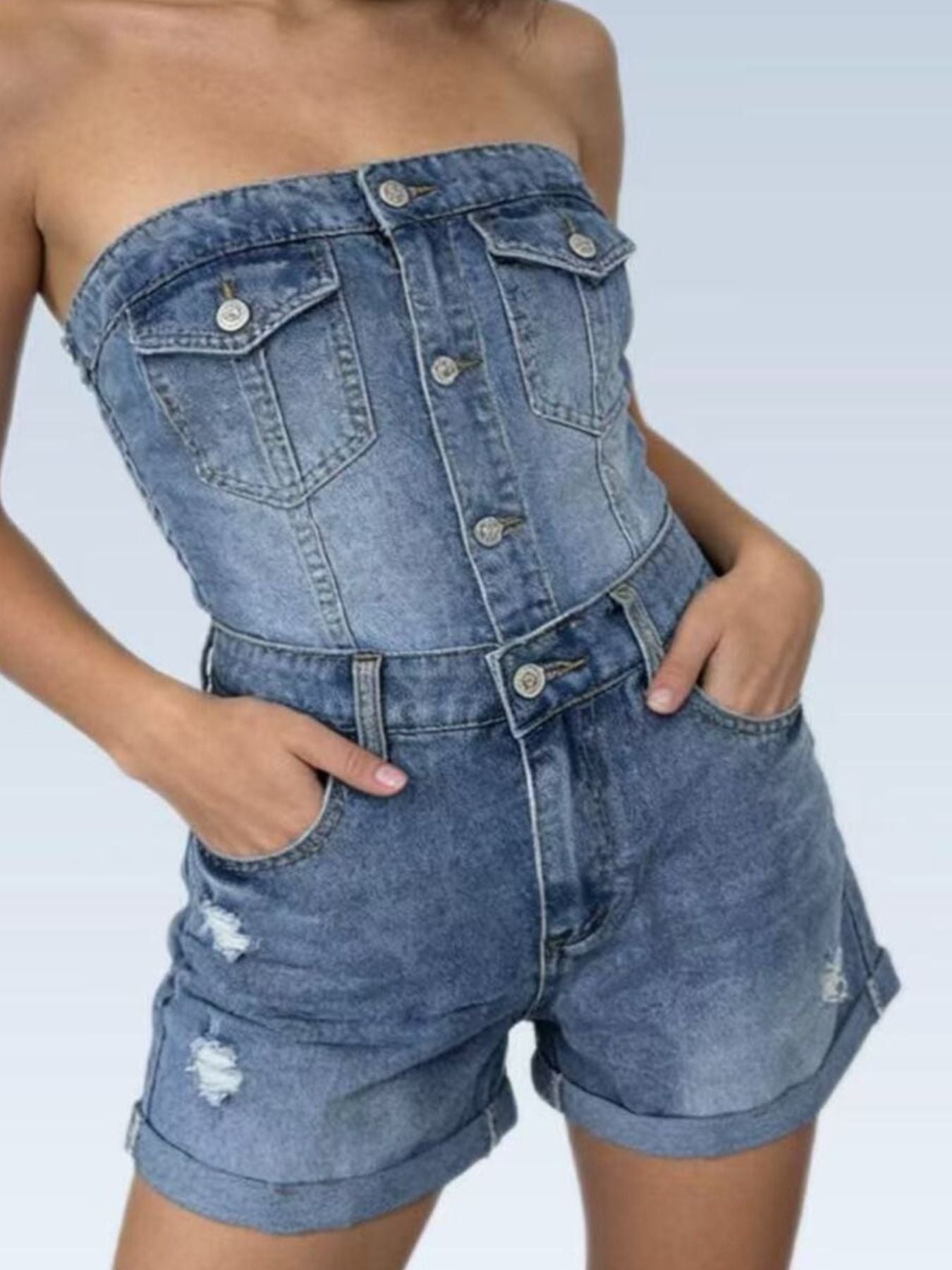 Chic distressed high-waisted denim shorts in light blue with cuffed hems and pocket details.