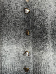 Gray ombre knit cardigan with heart buttons and textured buttons.