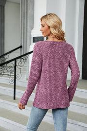 Ribbed tunic top in red-violet with button detail and asymmetric hem.