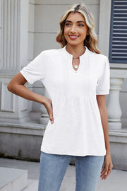 White pleated yoke keyhole tee with short sleeves and a relaxed fit.