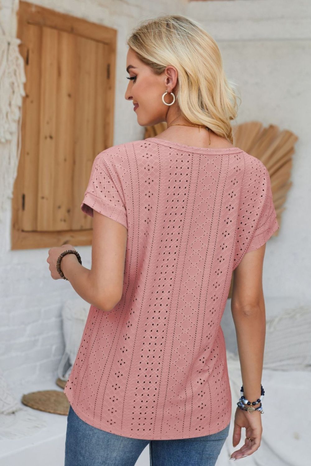Perforated eyelet cuffed tee in blush pink with short sleeves and a relaxed fit.