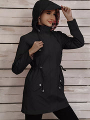 Black drawstring trench coat with plaid lining and snap-down pockets.