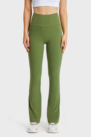 Green flare yoga pants with a high waist and breathable fabric.