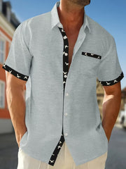 Grey waffle textured button-up shirt with bird print trim and pocket