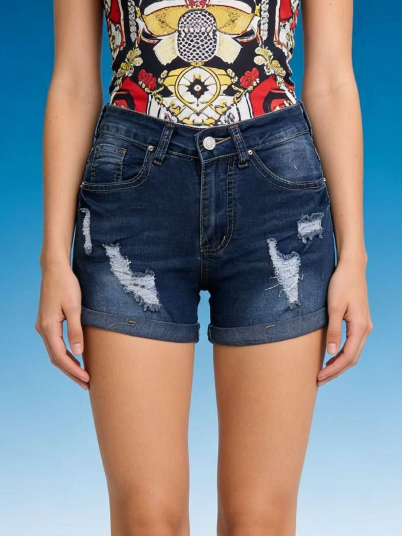 Dark blue distressed denim shorts with cuffed hem and button closure.