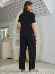 Black silk-blend lounge shirt and pants set with a collared neckline and short sleeves.
