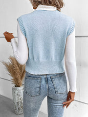 Light blue knit vest with ribbed trim and crew neck, worn over a white turtleneck.