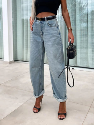 Baggy light wash denim barrel leg jeans with cuffed hems and a buttoned fly.