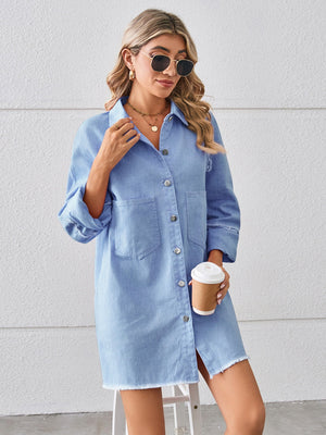 Light blue denim shirt dress with raw hem, button front, and chest pockets.