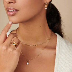 Prism cut gemstone necklace with 18K gold chain, layered with a paperclip chain necklace.