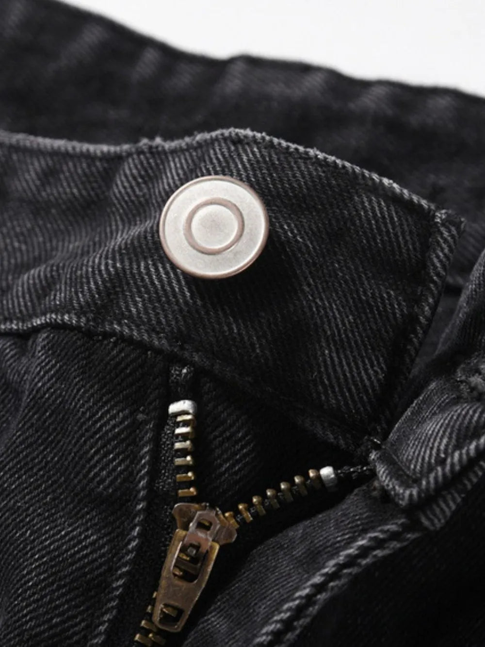 Black denim jeans with button and zipper detail