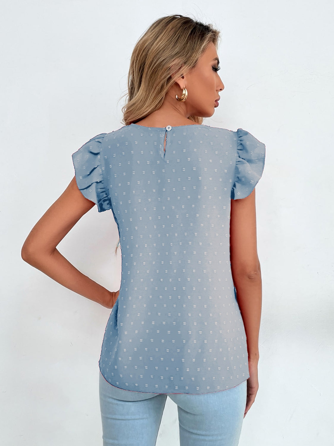 Light blue dotted swiss blouse with keyhole back and ruffle sleeves.