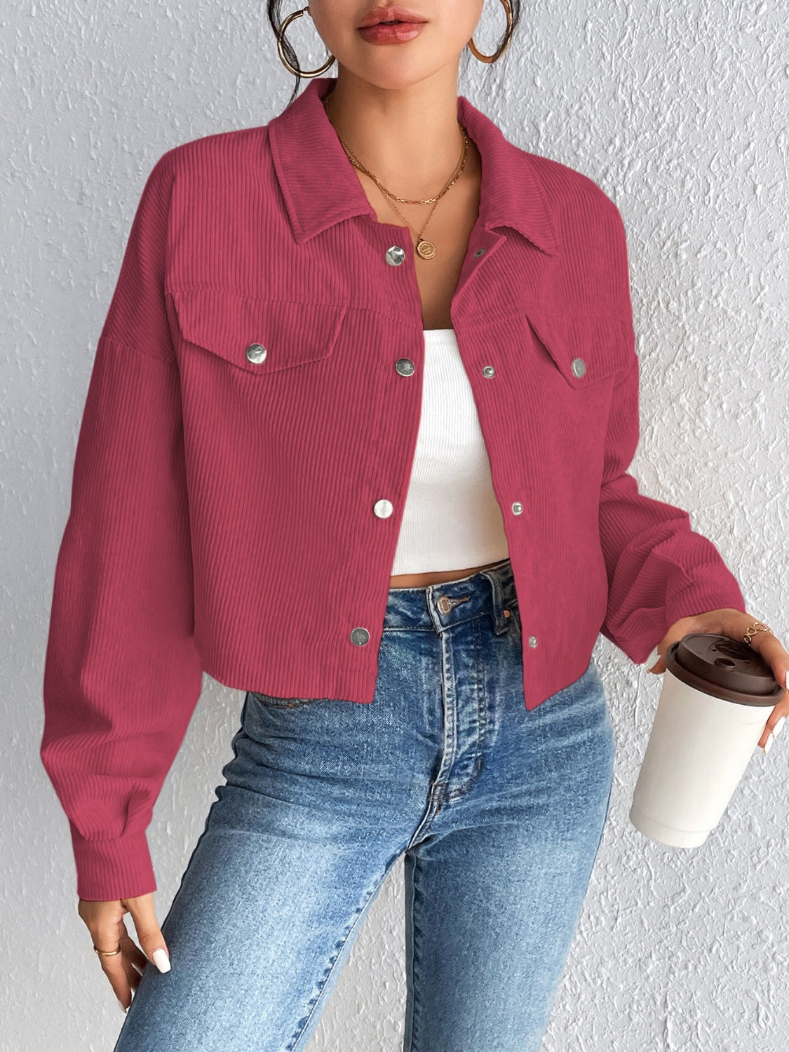 Cropped corduroy jacket in cerise with snap front and chest pockets.