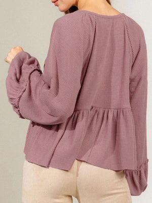 Dusty pink ribbed peplum blouse with ruffled cuffs and balloon sleeves.