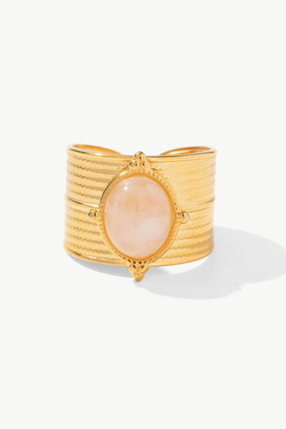 Textured gold cuff ring with a pale pink stone and boho design.