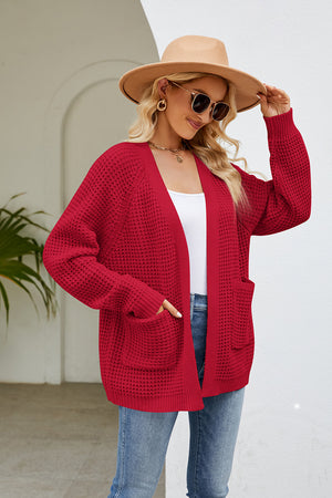 Red waffle knit raglan pocket cardigan with open front and long sleeves.