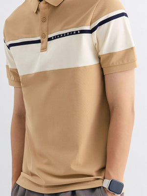 Men's tan cotton polo with color block design and navy stripe detail