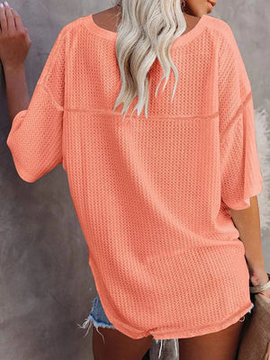 Coral pink waffle knit relaxed v-neck t-shirt with short sleeves.