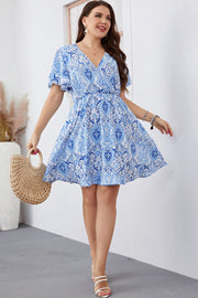 Pastel blue medallion print mini dress with flutter sleeves and a V-neck.