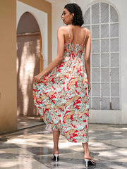 Chic floral midi dress with spaghetti straps and smocked bodice in red and blue paisley print.