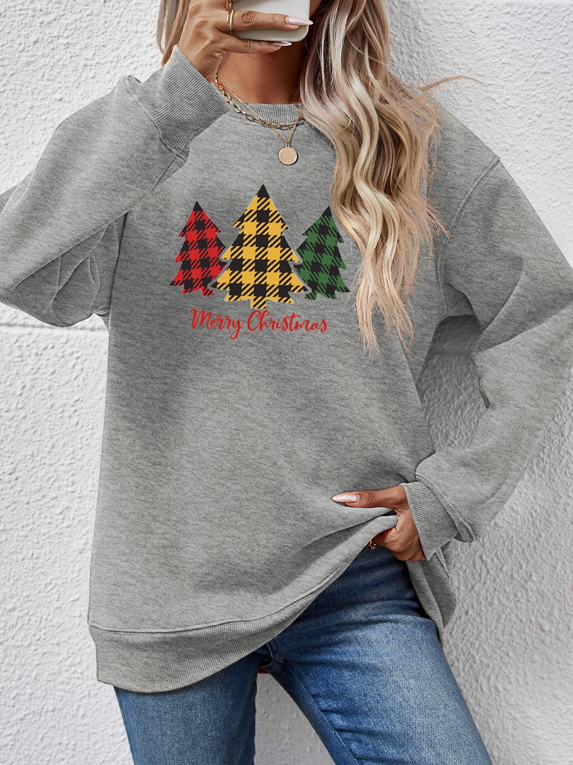Gray crewneck sweatshirt with plaid Christmas trees and Merry Christmas text.