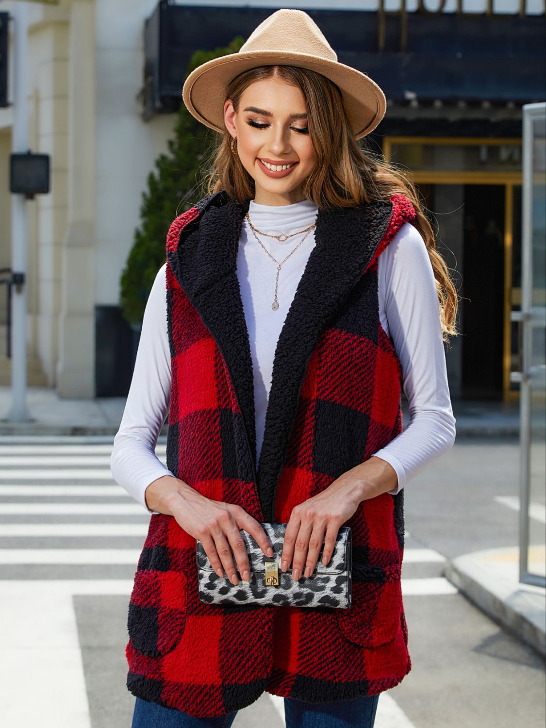 Reversible buffalo check vest in deep red and black with sherpa lining and hood.