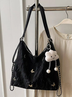 Black shoulder bag with butterfly embellishments and cloud charm