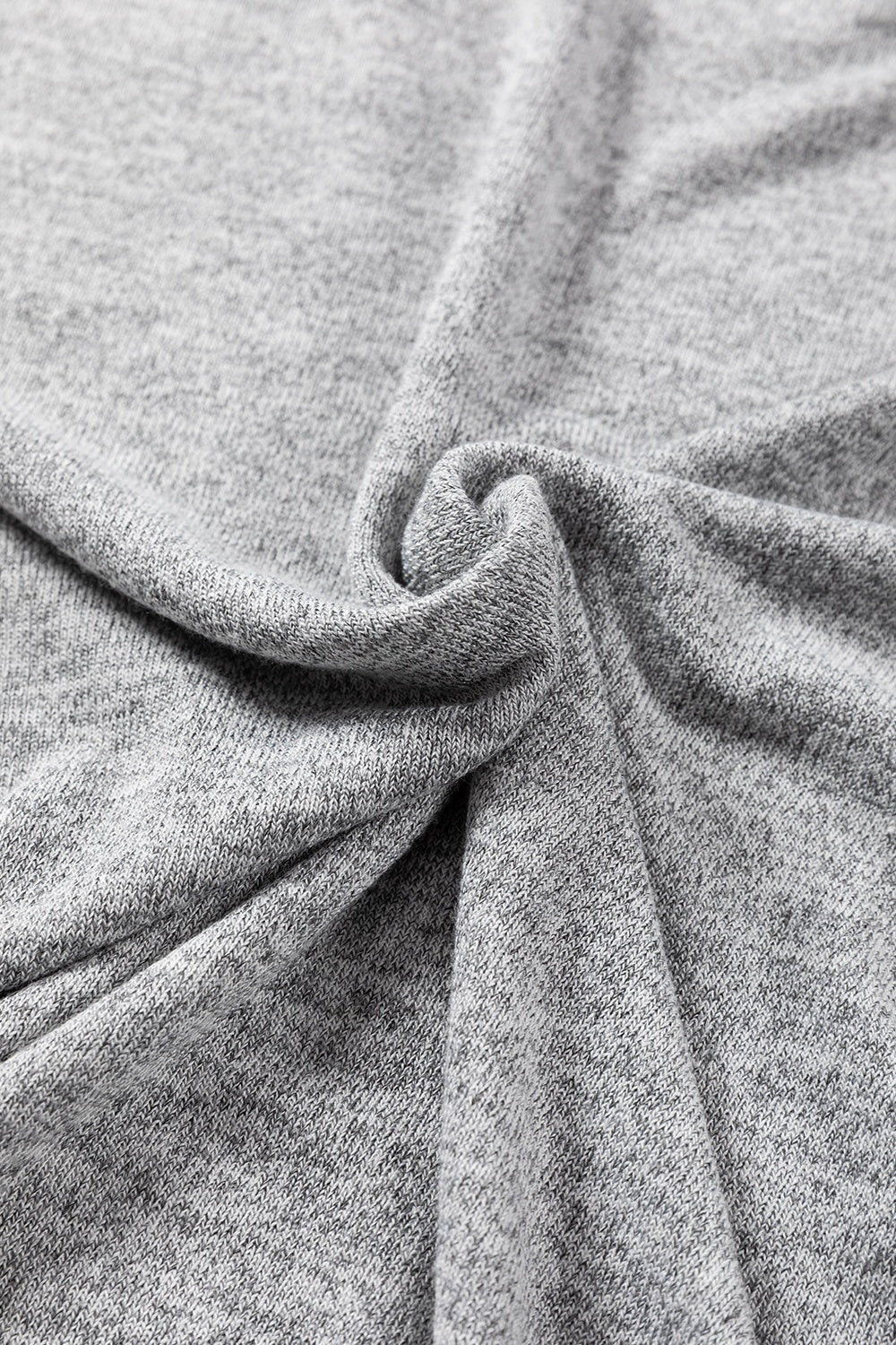 Dark gray slouchy knit top with button details, showing fabric texture.