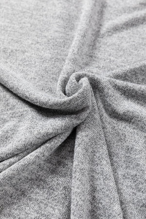 Dark gray slouchy knit top with button details, showing fabric texture.