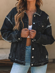 Black denim trucker jacket with raw hem and distressed details.