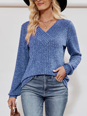 Cobalt blue ribbed V-neck pullover sweater with long sleeves.