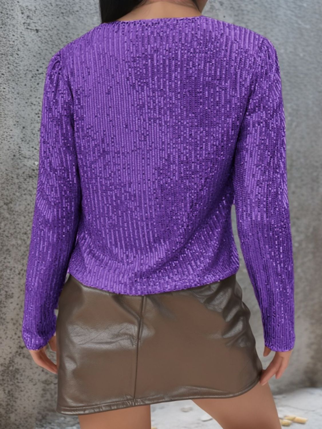 Purple sequin bolero jacket with long sleeves and puffed shoulders.